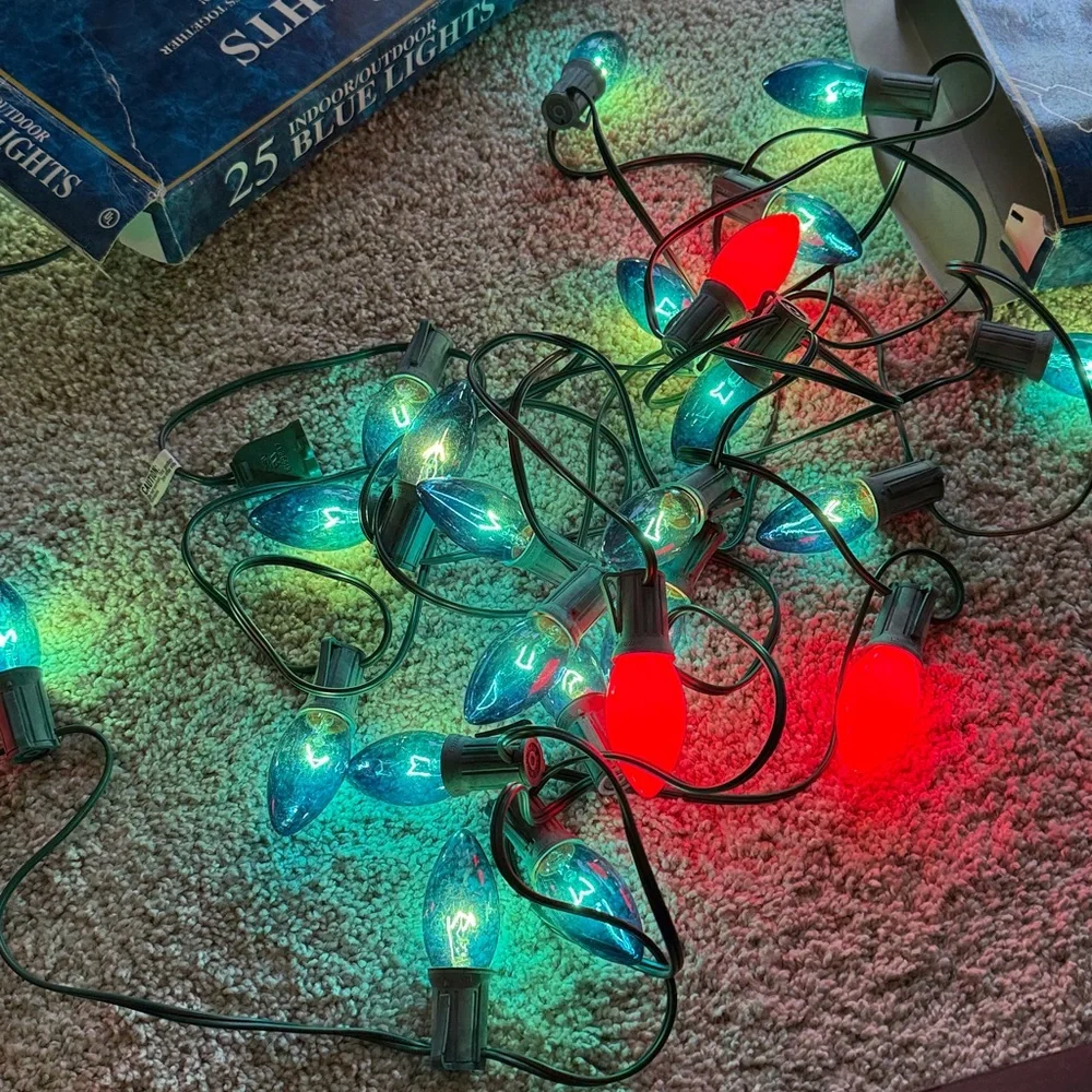 25 Indoor/Outdoor Blue String Lights Set of 2 boxes. One string has 4 red bulbs.